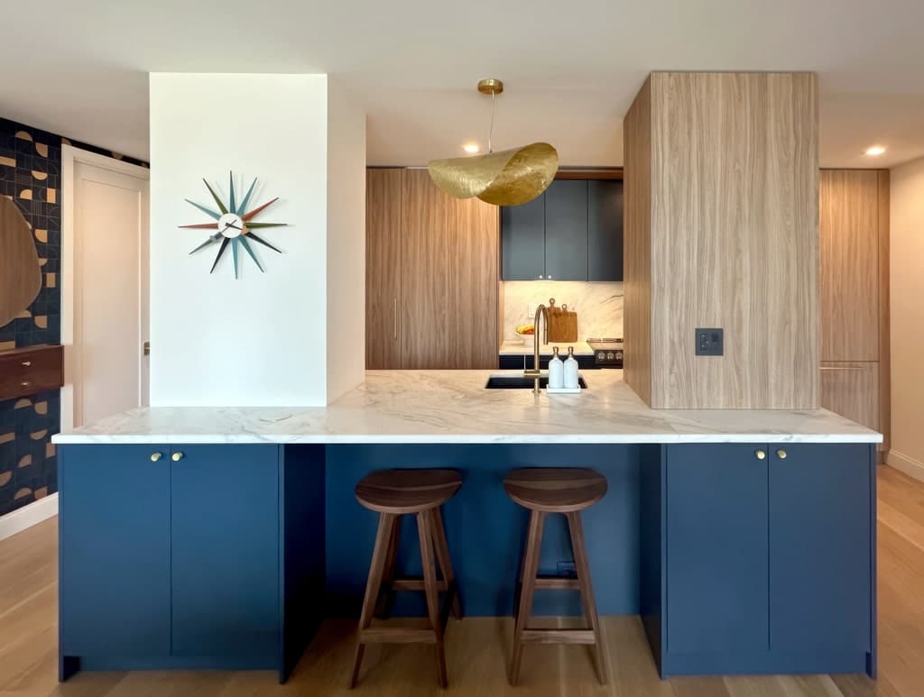 Modern Manhattan kitchen using MandiCasa cabinets in a deep blue palette with bronze accents