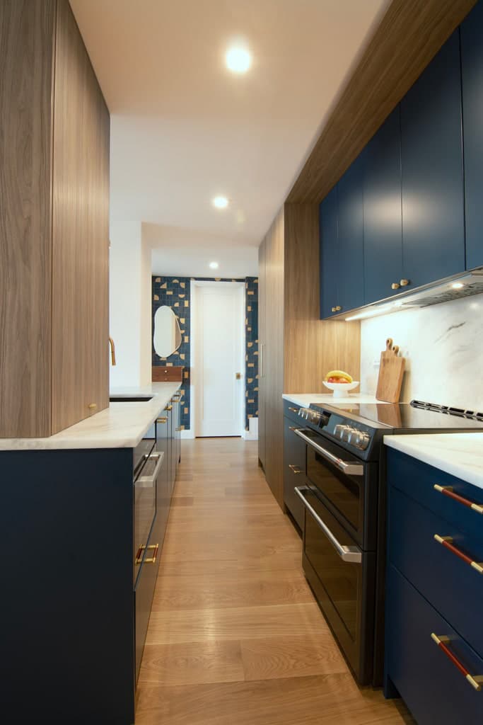 Galley kitchen in Manhattan home with MandiCasa Yota cabinets in deep blue.