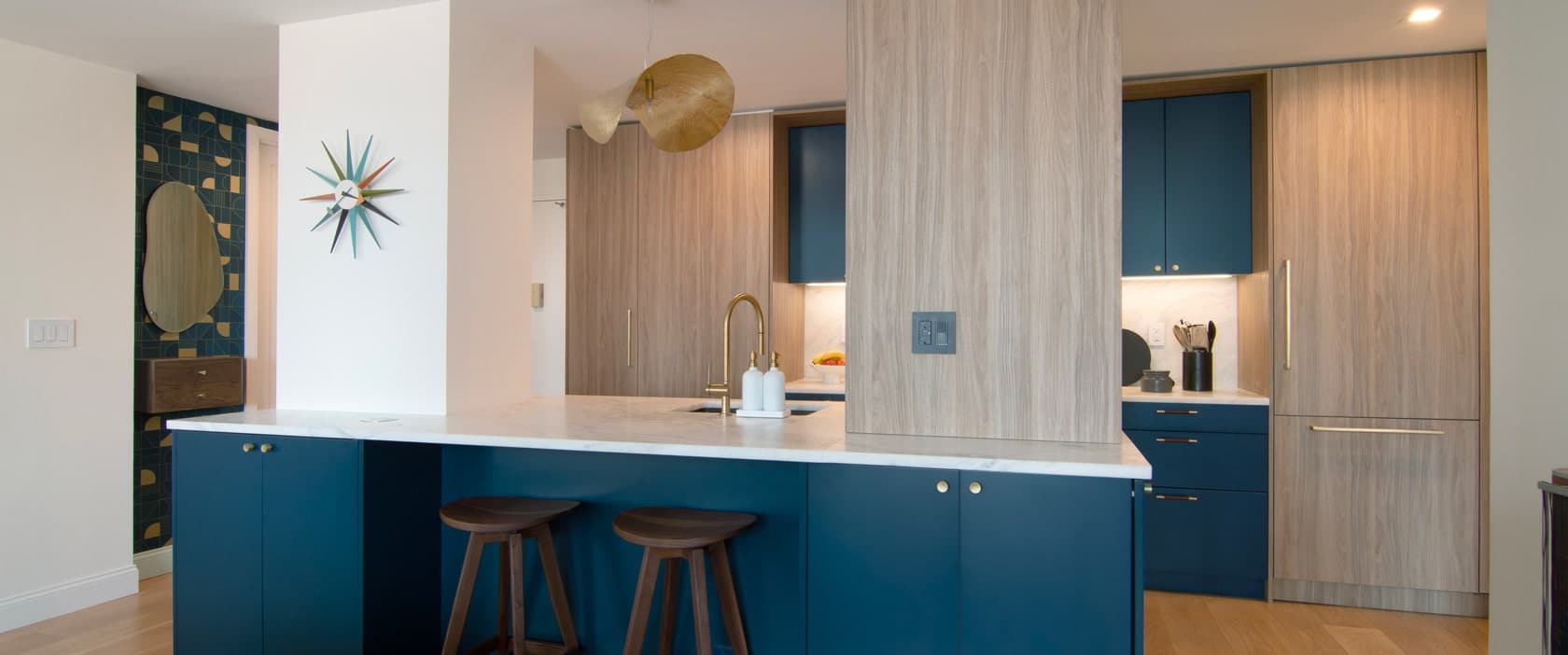 Modern Manhattan kitchen using MandiCasa cabinets in a deep blue palette with bronze accents