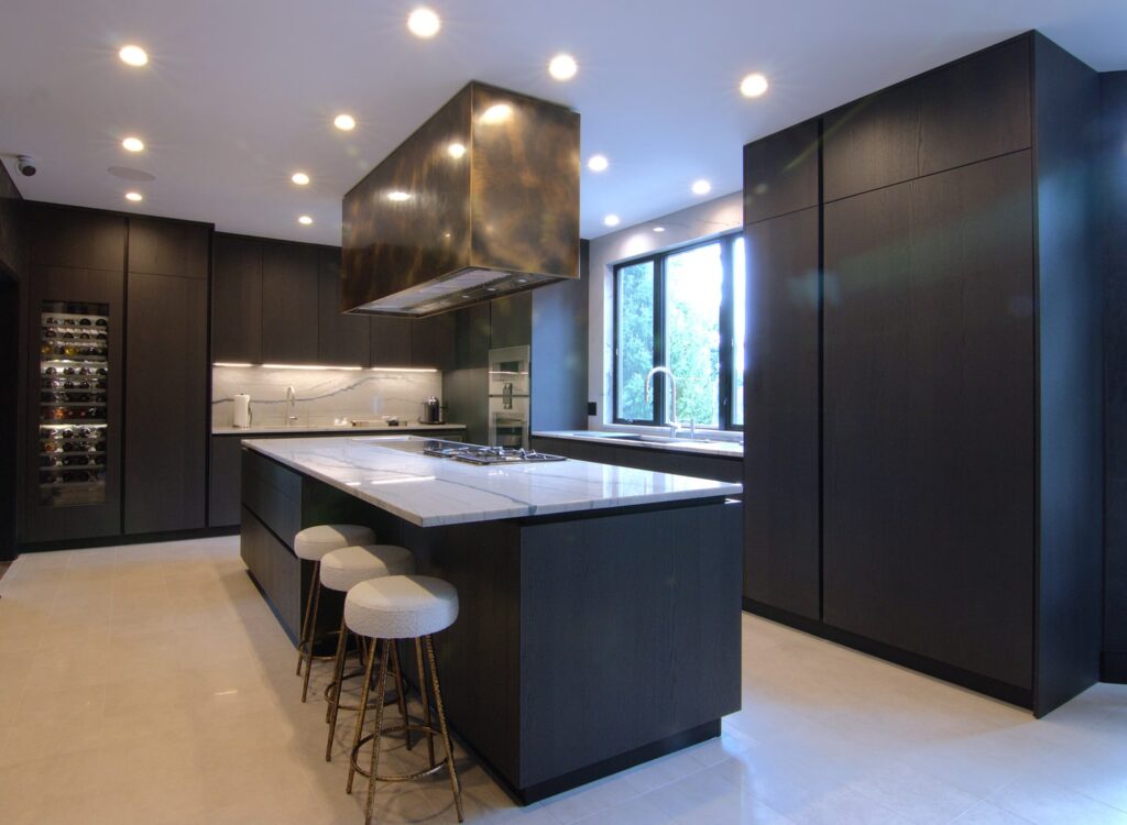 Modern L-shaped kitchen with Italian dark oak cabinets and countertops in white Quartzite Meridian.