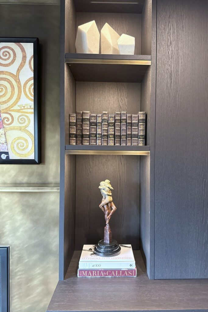 Italian luxury dark oak cabinets and open shelf niches with Richard MacDonald sculpture on display