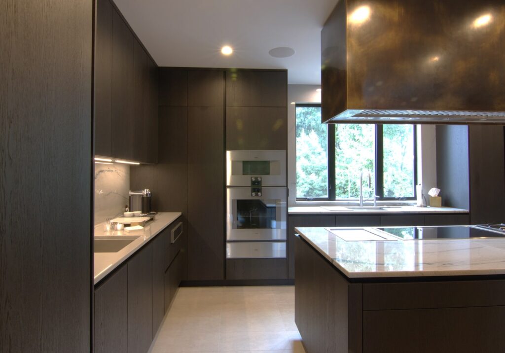 Luxury New York kitchen in Italian dark oak cabinets with integrated Gaggenau appliances in stainless steel.