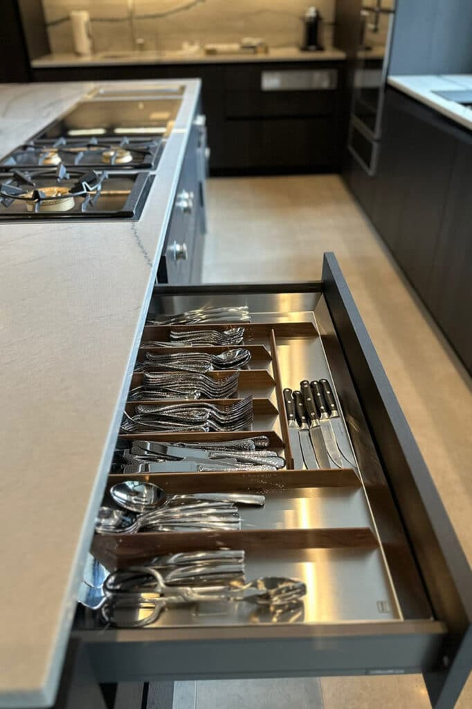 Luxury kitchen with drawers in stainless steel and walnut.