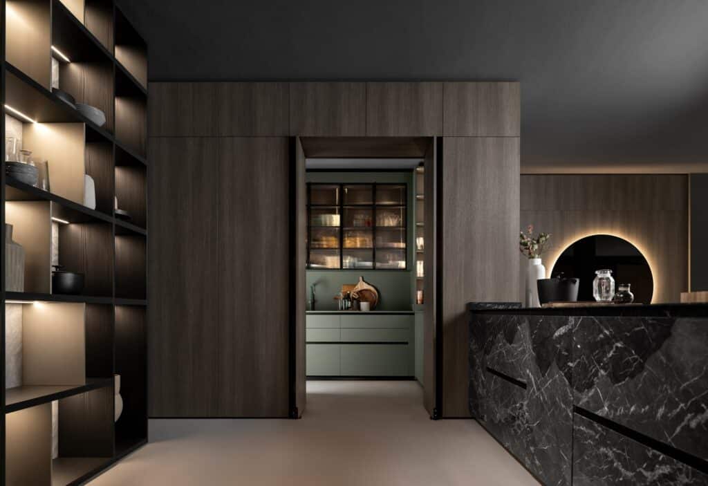 Custom swing doors blended within the pantry wall and connecting a home's formal kitchen to the hidden wet kitchen.