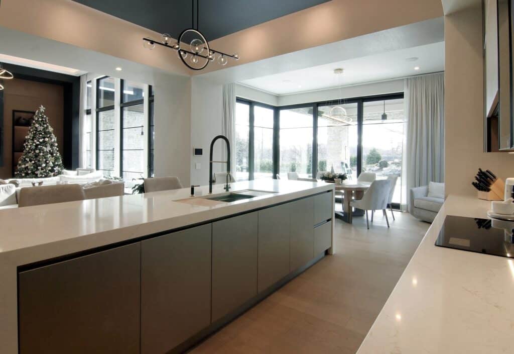 Modern kitchen with island opening up to dining room and living room in a spacious open floorplan design